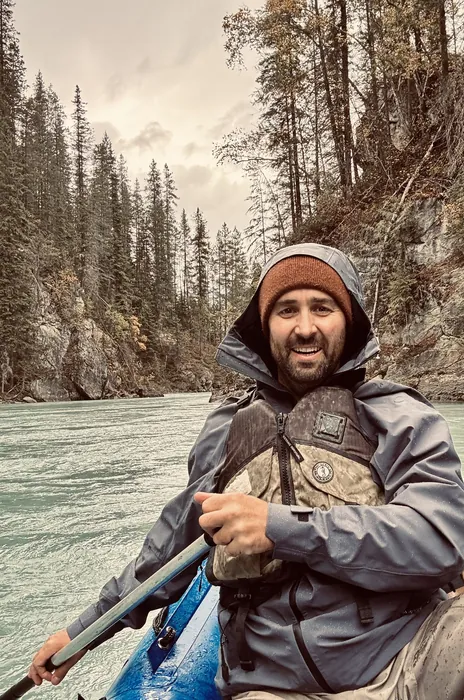 Dave Trerice paddling a canoe down a river