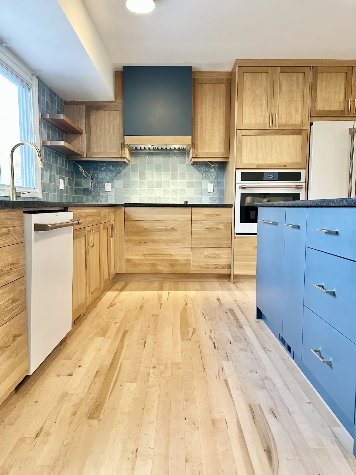 Hickory kitchen with a blue painted base run and a green tile backsplash